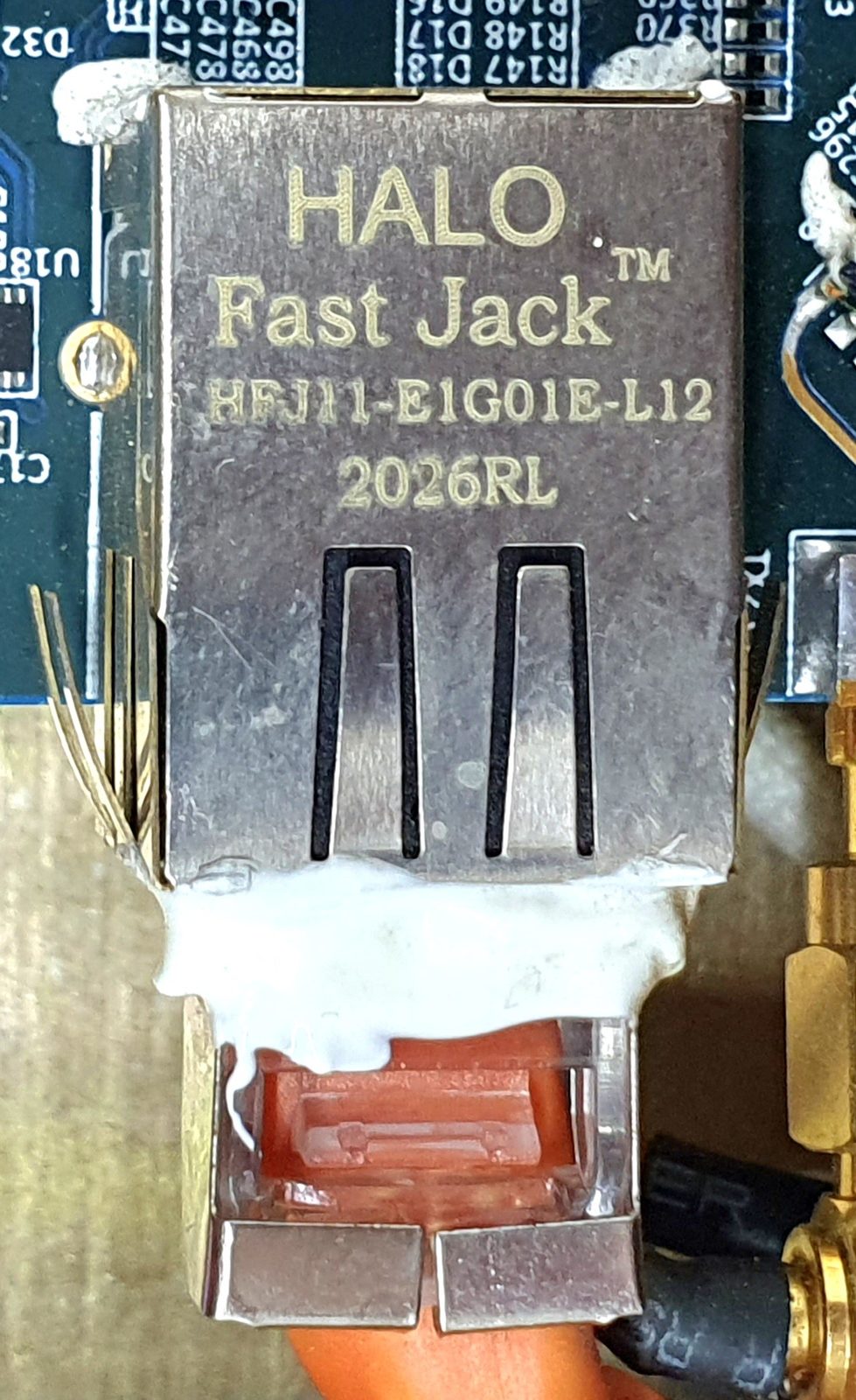 Modular connector, marked HFJ11-E1G01E-L12 2026RL