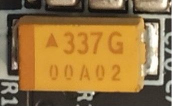 Tantalum SMD capacitor, marked 337 G 00A02