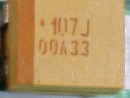 Tantalum Capacitor, marked 107J 00A33