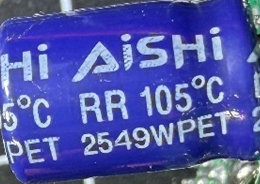 Capacitor, marked ISHI RR 105C