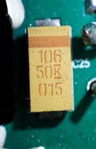 Tantalum capacitor, marked 106 50K 015