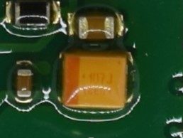 Tantalum SMD capacitor, marked 107 J 18E01